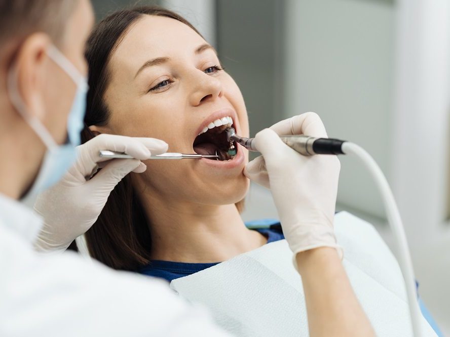 A patient in the dental chair during a professional scaling procedure