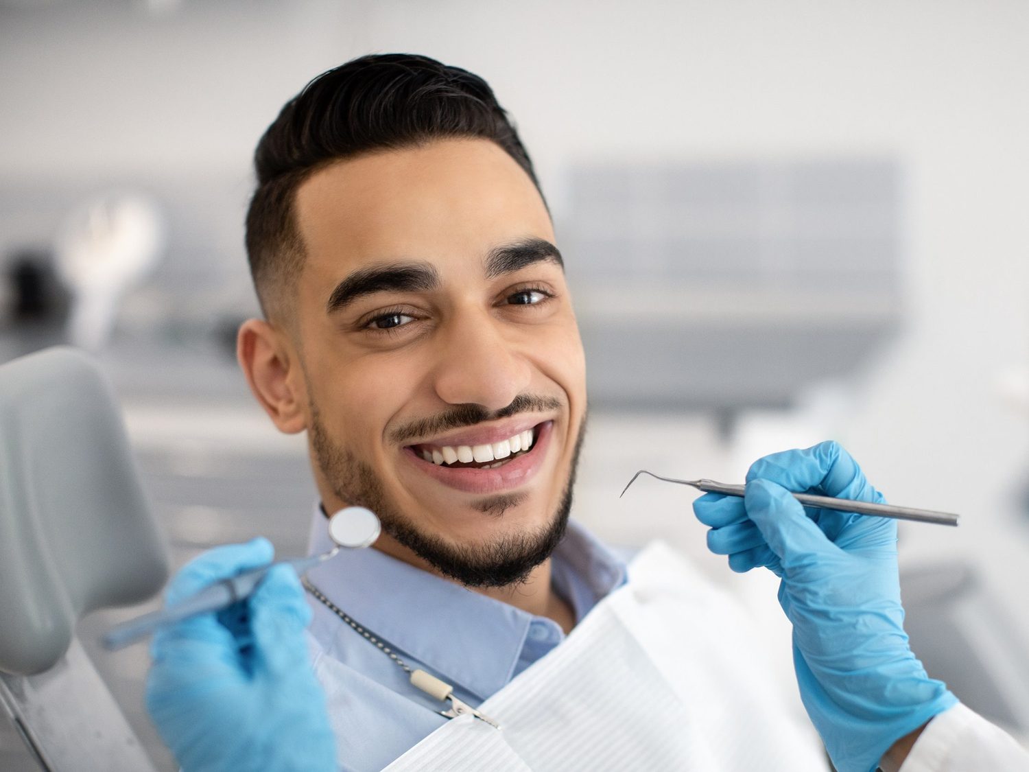 A patient smiling in the dental chair