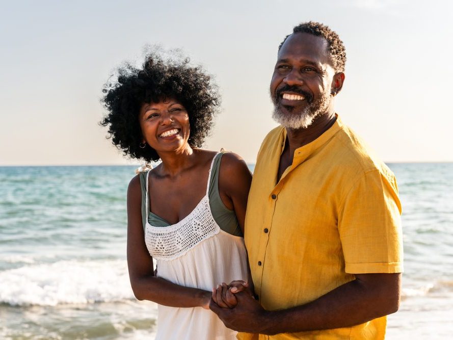 A couple smiling together on the beach