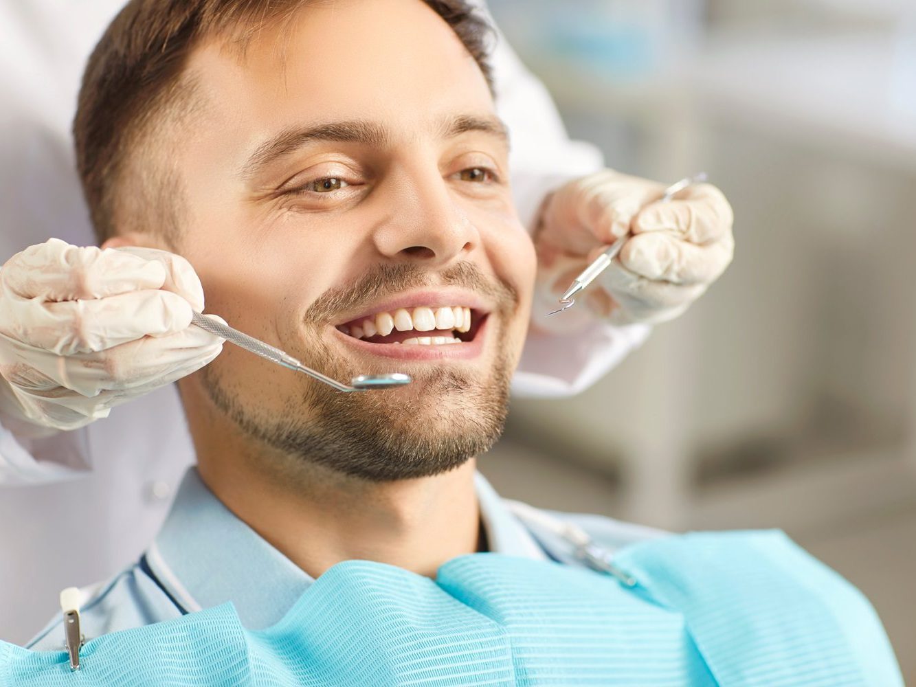 A dentist performing a dental examination on a patient during a clinic visit