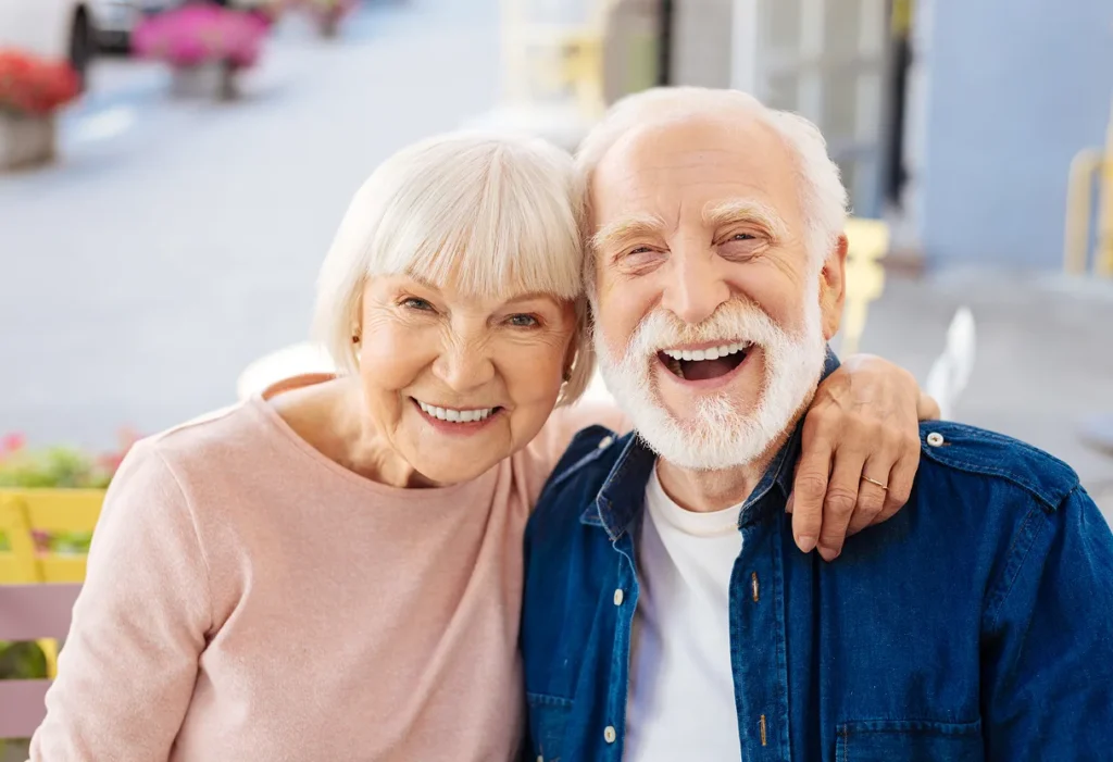 A dental implant specialist talking with a patient inside a modern dental clinic.