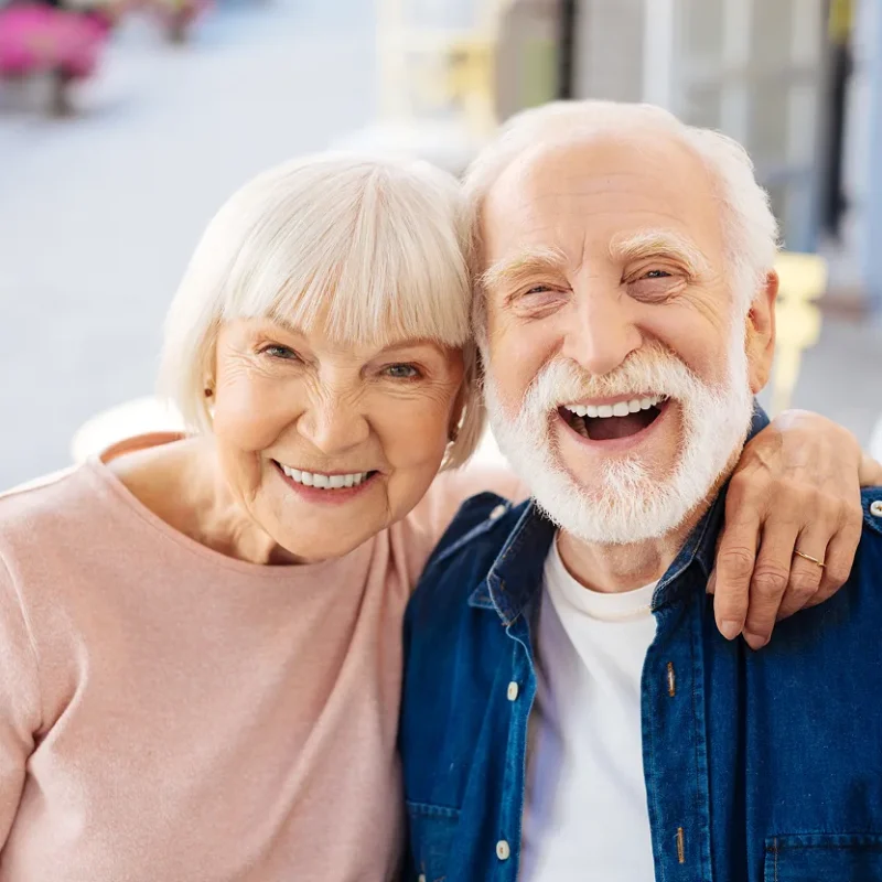 A dental implant specialist talking with a patient inside a modern dental clinic.