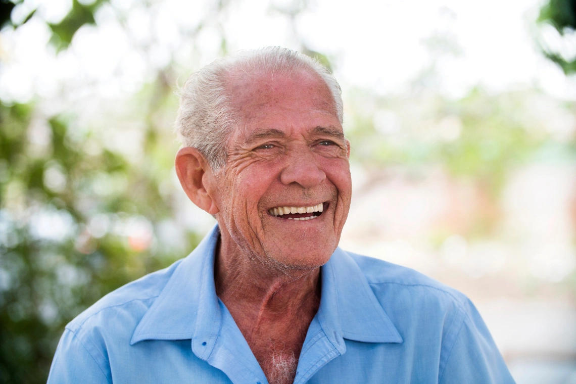 A dental implant specialist talking with a patient inside a modern dental clinic.